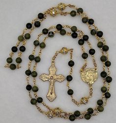 Beautiful handmade green southern jade Miraculous Medal Rosary made with 6mm southern jade Hail Mary beads, 8mm round golden filigree rhinestone Lord's Prayer beads, 2mm gold plated stainless steel accent beads, a beautiful golden ornately decorated Miraculous Medal centerpiece, and a golden Grape and Leaf Crucifix. All the eye pins, chain and split rings are gold nickel plated stainless steel for strength and durability. A rosary prayer guide and organza bag are included. All of the rosaries, c Gold Jade Beaded Jewelry, Gold Jade Round Beads Jewelry, Gold Jade Round Beaded Jewelry, Green Jade 8mm Beads Jewelry, Green Jade Jewelry With 8mm Beads, Rosary Prayer Guide, Prayer Guide, Rosary Prayer, Lord's Prayer