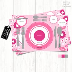 a pink place mat with utensils, spoons and plates on it in front of a white wooden background