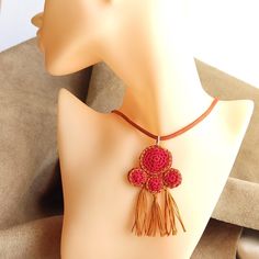 This crochet necklace is designed and created by me. It is inspired by the ancient Greek jewelry and is delicate and elegant with a perfect combination of bright red and camel brown colours. It comes with a leather strap in camel brown colour. MEASUREMENTS: Pendant Motif height 7 cm Pendant Motif width   4 cm Leather Strap length     45 cm You can see more designs of small crochet necklaces in my Shop by visiting  the Small Crochet Necklaces Section  following the link below: https://www.etsy.co Brown Tassel Necklaces As Gifts, Red Bohemian Crochet Jewelry, Bohemian Brown Crochet Jewelry, Brown Bohemian Crochet Jewelry, Crochet Pendant, Beige Colours, Crochet Necklaces, Ancient Greek Jewelry, Tassel Necklace Boho