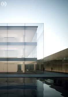 an empty building with glass walls and water reflecting it's reflection in the pool