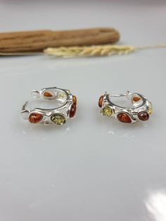 Baltic Amber and Sterling silver 925, with hallmarks. Small cute multi colour hoop earrings. Earrings length (diameter of the circle) 1.8 cm https://www.etsy.com/shop/AmberLithuania?ref=simple-shop-header-name&listing_id=780205095&section_id=27948198 Sterling Silver Clip-on Hoop Earrings As Gift, Multicolor Sterling Silver Earrings For Anniversary, Multicolor Hoop Earrings For Anniversary, Multicolor Clip-on Round Earrings, Multicolor Huggie Earrings For Gifting, Multicolor Huggie Earrings For Pierced Ears As A Gift, Small Hoop Clip-on Earrings For Gift, Multicolor Round Huggie Earrings As Gift, Multicolor Round Huggie Earrings For Gifts