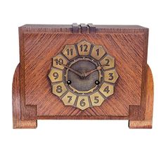 an old wooden clock with roman numerals on the face and numbers in gold