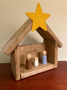 a wooden nativity scene with a star on top