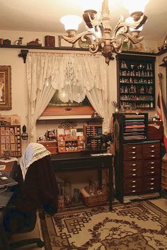 a room with many items on the floor and a chandelier hanging from the ceiling