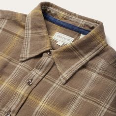 This button-front flannel shirt features an exclusive brown plaid pattern and is crafted from 100% cotton that has been yarn-dyed for rich, lasting color. It has no front yoke, a shallow straight back yoke with pleats, square pockets with flaps and button closures, two-button adjustable cuff, as well as contrast inside denim trim. Cut in our Modern Fit, for a trim, neat appearance that allows for comfort and freedom of movement. Exceedingly durable and always comfortable, our shirts are hard-wea Earthy Clothes, Allen Solly, Brown Flannel, Sleeve Placket, Photography Product, Straight Back, Brown Shirt, Mens Flannel Shirt, Fashion Suits For Men