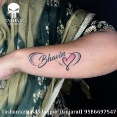 a man with a tattoo on his arm that says bhairi and has two hearts in it