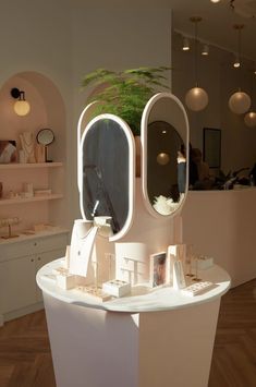 the interior of a beauty salon with mirrors and accessories on display in front of it