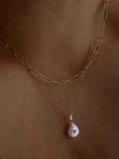 A delicate coin pearl inlayed with a single cubic zirconia gemstone, hanging from your favorite chain. All chains, except the snake chain, measure 16" with a 2" extender. Snake chain measures 18" with a 2" extender. Gold Bond, Coin Pearls, Figaro Chains, Single Stone, The Snake, Pearl Pendant Necklace, Timeless Accessories, Box Chain, Pearl Pendant