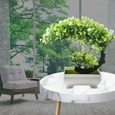 a white table with a potted plant sitting on it's side in front of a window