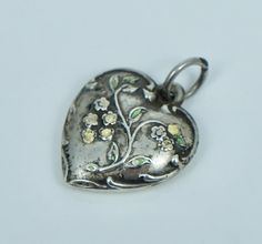 Vintage sterling silver and enamel puffy heart charm  Measures 5/8 inches wide by just under 3/4 inches tall  Significant loss to the enamel  Please ask any questions, always open to offers, and free shipping anywhere in the USA! Heart-shaped Silver Enamel Jewelry, Silver Heart-shaped Enamel Jewelry, Silver Enamel Heart Charm Jewelry, Silver Enamel Jewelry With Heart Charm, Burning Desire, Puffy Heart Charms, Puffy Heart, Charm Bracelets, Vintage Sterling Silver