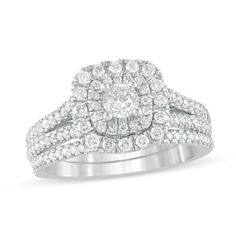 Make every moment shine with this stunning diamond bridal set. Crafted in cool 10K white gold, the glamorous engagement ring showcases a 1/4 ct. diamond wrapped in two cushion-shaped frames of diamonds. Additional diamonds line the ribbons of the split shank. Completing her ensemble, the coordinating wedding band shimmers with diamonds. Radiant with 1 ct. t.w. of diamonds and a brilliant buffed luster, this bridal set is meant to be hers. Glamorous Engagement Rings, Diamond Bridal Sets, Split Shank, Bridal Set, Bridal Sets, Wedding Band, Wedding Bands, Diamond Ring, Engagement Ring