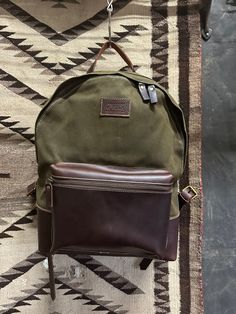 Durable backpack made of waxed canvas and leather. interior has a padded divider with a compartment for a laptop or iPad. Not reinventing the wheel here. Simple, classic, rugged and made to carry all of your daily essentials. Dimensions 14"H x 12"W x 5"D Waxed Canvas Backpack, Durable Backpack, Classic Backpack, Canvas Backpack, Waxed Canvas, Daily Essentials, Leather Interior, Divider, Ipad