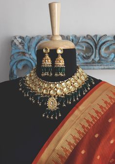 Emerald Green Gold Plated Kundan Polki Bridal Indian Choker Necklace Set with Jhumka Earrings embellished with Green Stones and Shell Pearls inspired by Sabyasachi jewellery style. Faux glass polki and shell pearls embellished Gold Plated Kundan Polki Bridal Indian Choker Necklace Set with Chandbali Earrings highlighted with red onyx tumble stones. Indian jewellery set, Indian Choker necklace set, Indian bridal jewellery, Indian wedding jewellery. Indian Necklace Set with Chandbali earrings, Ear Gold Chandbalis With Tilla For Designer Wear, Designer Chandbalis With Tilla For Diwali, Designer Tilla Chandbalis For Diwali, Bollywood Style Chandbalis With Tilla For Designer Wear, Kundan Jhumkas For Festivals, Designer Kundan Jhumkas With Meenakari, Traditional Jhumkas For Designer Festivals, Traditional Meenakari Jhumkas For Designer Wear, Designer Kundan Chandbalis With Tilla Detail