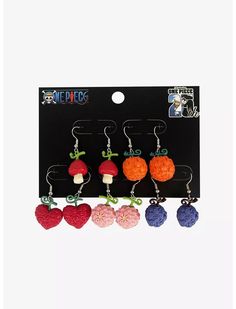 four pairs of earrings in the shape of hearts and mushrooms with bows on each ear