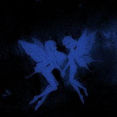 two blue tinkerbells in the dark with their wings spread out and glowing