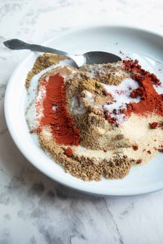 a white bowl filled with spices on top of a table