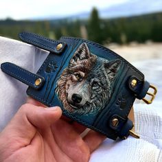 "Hand tooled leather wristband with Wolf design.  This stylish  wristband features a unique design, with a hand-crafted wolf on the front.  Crafted from high-quality leather, this wristband is both durable and stylish.  The wolf muzzle is hand-carved and hand-painted onto the leather, ensuring that each  wristband is unique and one-of-a-kind. CUSTOM orders are always available. Simply send me a message regarding whatever personalization or change you would like to add to your order, and I will r Leather Bracelets With Wrist Strap As Fashion Accessory, Adjustable Blue Engraved Cuff Bracelet, Handmade Custom Leather Bracelet, Blue Leather Bracelet As Gift, Blue Leather Bracelet For Gifts, Custom Handmade Leather Bracelets, Adjustable Blue Leather Cuff Bracelet, Hand-tooled Leather Bracelet For Gift, Hand Tooled Leather Bracelets As Gift