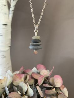 "Beach Glass Necklace, Stacked Stone Pendant, Stone Cairn Nature Jewelry, Organic Brown Stone and Sea Glass, Boho Jewelry, Yoga Gift This unique multi stacked stone necklace is made entirely of stones, pottery and beach glass found in Upstate NY on the beaches of Lake Ontario and surrounding fresh water lakes. Every stone handpicked out of the water by us! It is a perfect gift to send to someone from this area and remind them of home. This necklace has a very special meaning. Stacked stones or Cairns are used in marking paths or trails and is said to be an ancient reference. Balancing stones is about balancing your life or to mark one's personal passage. We use only fine and sterling silver for all of our jewelry and findings, including our handmade ear wires. Shaped and hammered for simpl Stacked Stones, Stone Cairns, Beach Glass Necklace, Brown Stone, Lake Ontario, Upstate Ny, Stacked Stone, Yoga Gifts, Cairns