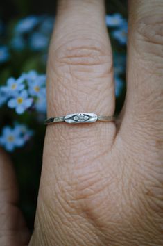 These hand hammered sterling silver stacking bands feature the sweetest little forget me not flower. Don't forget to chose your size at checkout. This piece is made to order by me in my studio in Massachusetts. Please allow up to three weeks turn around time for your piece to be made. Please ask any and all questions before purchasing. I'm happy to answer them! This item is handmade, there may be slight variations or imperfections. Delicate Tiny Stackable Rings For Gifts, Dainty Hypoallergenic Stackable Promise Rings, Dainty Handmade Stackable Rings For Anniversary, Dainty Nickel-free Promise Ring, Tiny Delicate Flower Promise Ring, Dainty Sterling Silver Midi Rings For Promise, Dainty Sterling Silver Midi Rings For Anniversary, Delicate Tiny Flower Promise Ring, Adjustable Sterling Silver Promise Flower Ring