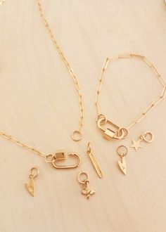 Introducing our Gold Carabiner Paperclip Charm Necklace, a perfect blend of elegance and practicality. This simple gold chain features a carabiner charm paired with a chic paperclip style, making it a standout piece in modern charm jewelry. Features Easy Bracelet Closure That Securely Twists Shut Modern Gold Bracelet Design Personalized With Added Charm Options Add A Heartfelt Engraving For A Perfect Gift For Her Ideal as a personalized gift, this necklace is perfect for any occasion, adding a t Modern Charms Bracelets, Modern Yellow Gold Charm Bracelet For Everyday, Modern Gold Plated Paperclip Bracelet For Everyday Wear, Elegant Jewelry With Carabiner Clasp, Modern Gold Plated Paperclip Bracelet For Everyday, Modern Gold Charm Necklace For Everyday, Gold Modern Charm Necklace For Everyday, Trendy Jewelry With Carabiner Clasp, Modern Gold Paperclip Bracelet With Lobster Clasp