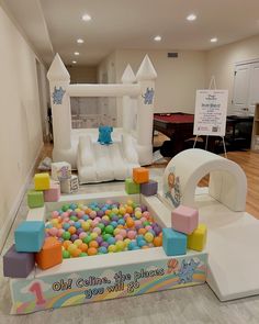 an inflatable castle with lots of balls and blocks on the ground next to it