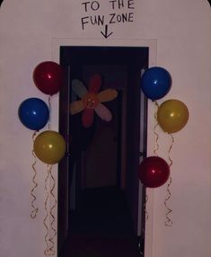 the door to the fun zone is decorated with balloons