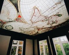 the ceiling is decorated with maps and windows