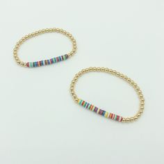 This listing is for 1 custom 14k gold filled and multicolored disc 4mm beaded bracelet. Each bracelet comes with 1.5 inches of multicolored disc beads and can be personalized to your desired length. Multicolored discs beads are a random mix of red, blue, green, yellow and red. These bracelets will not tarnish and look great alone or in a stack! Bracelets come in an organza pouch and make perfect gifts. Sizing Note: An average woman's wrist size is 7 inches and 6.5 inches is the most common lengt Rainbow Beads, Gold Beads, How To Make Beads, Delicate Bracelet, Beautiful Bracelet, Round Beads, Rope Bracelet, Beautiful Necklaces, Gold Filled