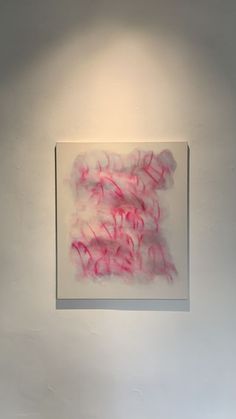 an abstract painting hangs on the wall