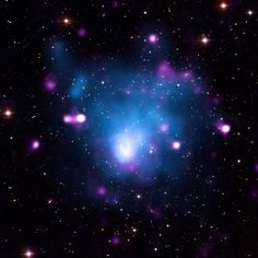 an image of a very bright blue object in the middle of some dark space with stars