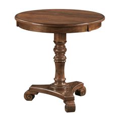 an old fashioned wooden table with wheels on the bottom and one foot resting on it's base