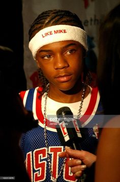 a young man with dreadlocks and a headband is interviewed at an event