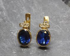 Gold Sapphire Earrings set with a Created Sapphire in a diamond cut, flawless clarity & Royal blue color, at 10x8mm, 6 Carats. Antique Earrings design made of Solid 925 Sterling Silver ☞ made to last. **The earrings are plated with 18k Gold (the thickest plating - 3 Micron) over Solid 925 Sterling Silver. Matching Ring: www.etsy.com/uk/listing/799193041 Matching Pendant - please ask me ⌛ Last pair of earrings left ⌛ For Pierced Ears - has a pin that goes into the ear and a leaver that securely c Vintage Sapphire Earrings, Antique Earrings Vintage, Vintage Earrings Gold, Morganite Pendant, Blue Antique, Bezel Earrings, Vintage Sapphire, Royal Blue Color, Emerald Earrings