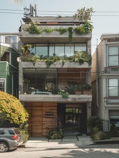 an apartment building with plants growing on the balconies