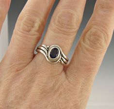 R1114- Sterling Silver Ring with a 7 x 5 mm Iolite, AAA quality, Size 8.5 . I can size it to fit, just contact me. No charge to size down, and no charge for one size up. The top of the ring measures 12 mm and the band is 2 mm. This ring is made by the Lost wax Casting method, were I make the design in wax and then cast it into silver. To learn more about Me and the Lost Wax Method please visit my website at www.denimanddiamondsjewelry.com Thanks for visiting, If you have any questions please fee Hand-forged Oval Moonstone Ring For Anniversary, Oval Hand Forged Moonstone Ring For Anniversary, Hand Forged Oval Moonstone Ring For Anniversary, Elegant Hand Forged Oval Moonstone Ring, Formal Oval Sapphire Stackable Ring, Oval Sapphire Stackable Rings For Gift, Oval Sapphire Stackable Rings As A Gift, Hand Forged Oval Sapphire Ring For Anniversary, Elegant Oval Amethyst Stackable Ring