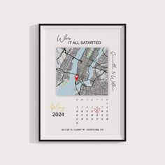 a wall mounted calendar with a city map in the middle and a red marker on it