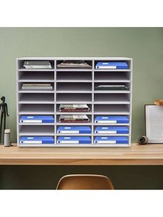 an office desk with many files and folders on it, including bookshelves