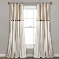 a white curtain hanging on the side of a window