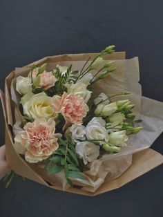 a person holding a bouquet of flowers in their hand