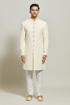 Cream sherwani floral pattern embroidery with thread and sequin work. Paired with a white churidar. - Aza Fashions Festive Off White Sherwani With Resham Embroidery, White Fitted Salwar Kameez With Naqshi Detailing, Off White Sherwani With Resham Embroidery For Diwali, Off White Straight Kurta Sherwani For Festive Occasion, Festive Off White Sherwani With Straight Kurta, Bollywood Off White Sherwani With Zari Work, Festive Off White Straight Kurta Sherwani, Festive Off-white Sherwani With Straight Kurta, Off-white Bollywood Sherwani With Zari Work