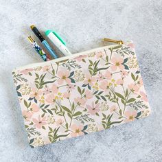 This super cute and practical planner pouch will keep all your planner supplies organized and ready to use. Great on your desk or on the go, these flat, zippered pouches are perfect for stickers, washi tape, pens, highlighters and more. Tame the chaos on your desk by storing your planner and accessories together! The large pouch measures 11.81 inches wide by 8.35 inches tall and can accommodate all please + thanks half letter spiral notebooks and planners. Choose from white or black zipper closures and non-woven polyester lining.  Details: * Vibrant, custom- printed 100% polyester  * Gold zipper pulls * Choice of white or black zipper/lining * Available in two sizes - Small (8.35x6 inches) or Large (11.81x8.35 inches) Designed with care at the please + thanks studio on the prairie of centr Pink School Organizer With Pen Slots, Pink School Organizers With Pen Slots, Portable Pink Stationery For Organization, Pink Portable Organizer For Personal Use, Cute Stationery For Back To School Organization, Pink Organizers For Everyday Use And Back To School, Cute Stationery Pen Holders For Organization, Cute Stationery With Pen Holders For Organization, Everyday Pouch Cosmetic Bag For Back To School