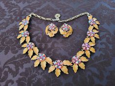 Vintage LISNER orange floral and pink stone necklace and earring set. Necklace measure 16 inches long 1 inch wide, earrings measure 1 inch and are clip-on style. Unsure of exact date of production but estimated 40's from history I know of owner. ALL stones intact, there is minor chipping of the orange on the leaves of the earrings. These stones shine like no tomorrow! One owner. Perfect for a spring wedding or event! Beautiful Vintage Set. Vintage Orange Jewelry With Matching Earrings, Pink Stone Necklace, No Tomorrow, Doll Jewelry, Set Necklace, Necklace And Earring Set, Pink Stone, Necklace Earring Set, Spring Wedding