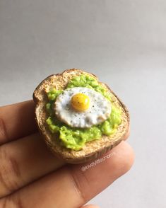 a tiny sandwich with an egg in the middle