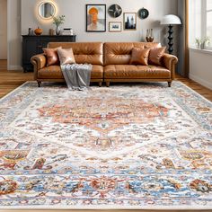 a living room with a couch, rug and pictures on the wall