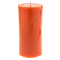 an orange pillar candle on a white background