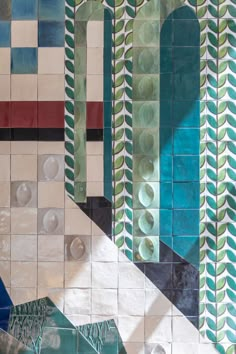 an artistic tile wall with various shapes and colors