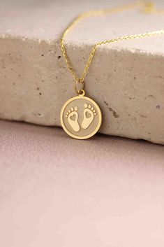 Gold Baby Feet Pendant -  Baby Feet Gold Necklace ● Material of pendant: Solid Gold 14k ( REAL GOLD ) ● Metal Stamp: 14k ( REAL GOLD ) ● The pendant is available in 5 sizes: - 12,7 mm / 0.5 inches (Diameter) - 14,0 mm / 0,55 inches ( Diameter ) In the photos - 15,3 mm / 0.6 inches ( Diameter ) - 16,5 mm / 0,65 inches ( Diameter ) - 19,1 mm / 0,75 inches ( Diameter ) ( In the photos the size is 14mm / 0.55 inches Diameter ) ( Jump Ring inner diameter: 4 mm ) ● Material of chain: Solid gold 14k ( Hypoallergenic Round Pendant Necklace For Birthdays, Hypoallergenic Round Pendant Necklace For Birthday, White Round Pendant Charm Necklaces For Birthday, White Round Pendant Charm Necklace For Birthday, White Round Charm Necklace For Birthday, Handmade Round Charm Necklaces For Birthday, Newborn Video, Baby Jewelry Gold, Baby F