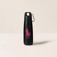 a black and pink water bottle with a red horse on it's side, sitting on a white surface