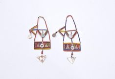 These African old tribal beaded earrings from the Masai Tribe of Kenya and would be a stunning addition to any jewelry collection. The intricate design and vibrant colors make them a true statement piece. The earrings are made from wire and beads and feature a unique aluminum metal. The earrings are collectors items and are perfect for both men and women. The main stone is glass and the ear area is the lobe. The beaded style and multicolor design are a beautiful representation of African ethnic and regional style of the Masai of Kenya. These earrings are a must-have for anyone who loves tribal jewelry. Museum Quality 6 1/4 Inches Long 3.5 Inches Wide Middle Top 2 Inches Wide Bottom Dangle 1.5 Inches Long AT BACARA WE STAND BEHIND ALL OF OUR MERCHANDISE. FULL MONEY BACK GUARANTEE WILL BE PR Masai Tribe, Jewelry Museum, Aluminum Metal, Kenya, Beaded Earrings, Statement Pieces, Jewelry Earrings Dangle, Jewelry Collection, Dangle Drop Earrings