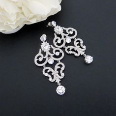 "Our rose gold bridal earrings are truly beautiful with scrolls upon scrolls of cubic zirconia encrusted elegance. At the top center of the earrings is a beautiful oval cz stone surrounded by small cz stones. These earrings are perfect for any special occasion gown. Earrings measure 2.5\" x 1.25\" MATCHING PIECES: https://www.etsy.com/listing/168621008/bridal-necklace-crystal-necklace-bridal?ref=shop_home_active_1 https://www.etsy.com/listing/525414037/rose-gold-bracelet-crystal-bridal?ref=shop_ Wedding Diamond Filigree Earrings, Wedding Filigree Diamond Earrings, Wedding Diamond Earrings With Filigree Detail, Wedding Diamond Earrings With Filigree, Cubic Zirconia Chandelier Earrings With Intricate Design As Gift, Intricate Cubic Zirconia Chandelier Earrings As Gift, Anniversary Bridal Earrings With Intricate Cubic Zirconia Design, Gift Cubic Zirconia Chandelier Earrings With Intricate Design, Exquisite Wedding Chandelier Earrings With Cubic Zirconia